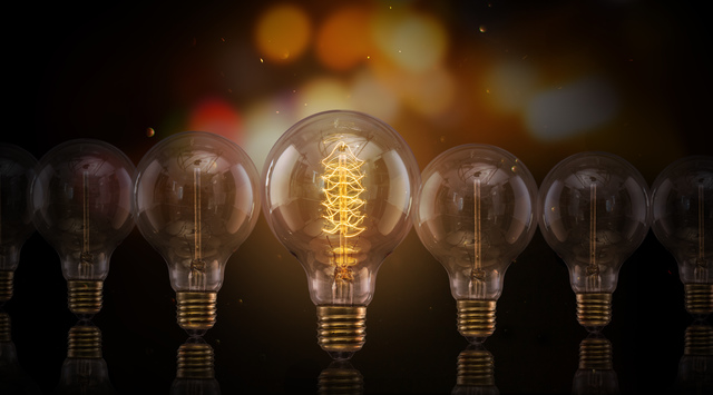 Vintage Edison light bulbs on dark background with empty space for text.