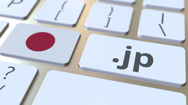コンピューターのキーボードのボタンにある日本語ドメイン「.jp」と日本の国旗。全国のインターネット関連の3Dレンダリング
